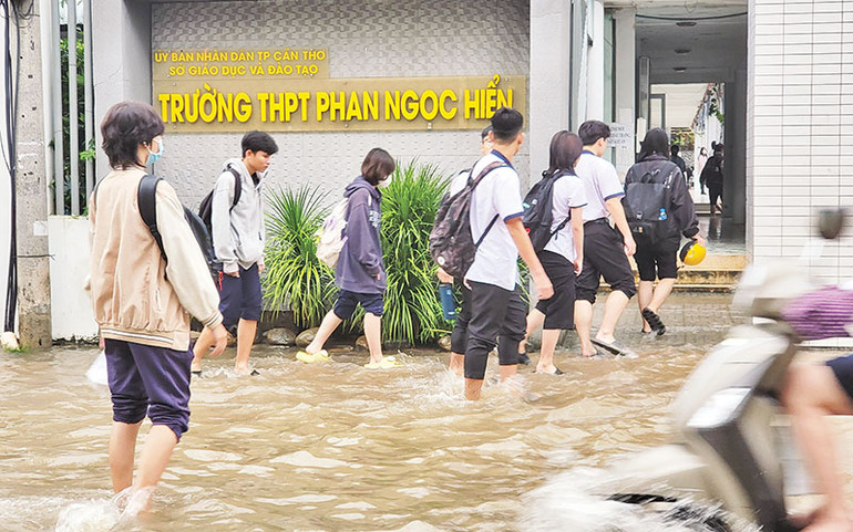 Học sinh phải lội nước để tới trường.