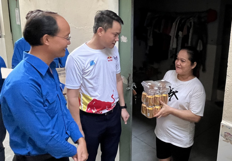 Phó Chủ tịch Thường trực Trung ương Hội Liên hiệp Thanh niên Việt Nam Nguyễn Kim Quy (áo trắng) thăm và tặng quà cho công nhân có hoàn cảnh khó khăn đang ở trọ tại xã Đức Hòa Hạ.