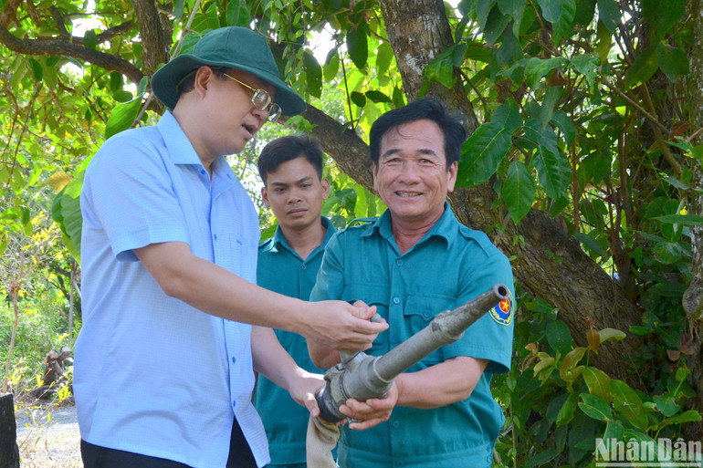 Bí thư Tỉnh ủy Cà Mau Nguyễn Hồ Hải (bìa trái) kiểm tra vận hành vòi chữa cháy đối với lực lượng “canh lửa” trên lâm phần rừng tràm U Minh hạ.
