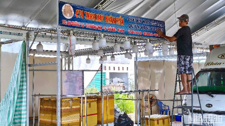 Tiểu thương tham gia hội chợ trang trí biển hiệu để chuẩn bị bố trí hàng hóa phục vụ hội chợ tại miền biển Sông Đốc.