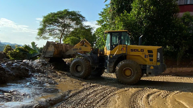 Máy móc và xe chuyên dụng dọn bùn đất sau hoàn lưu bão số 3 tại huyện Bảo Thắng.