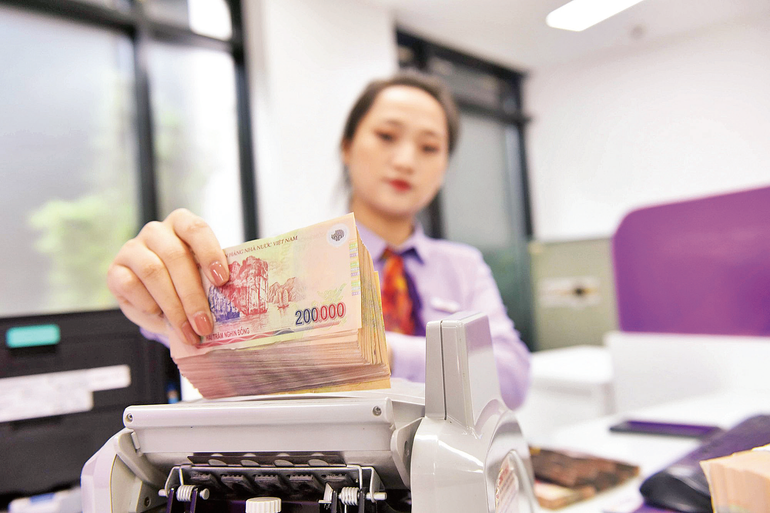 Đồng Việt Nam mất giá so với USD thuộc nhóm thấp nhất thế giới. Ảnh: Tâm An