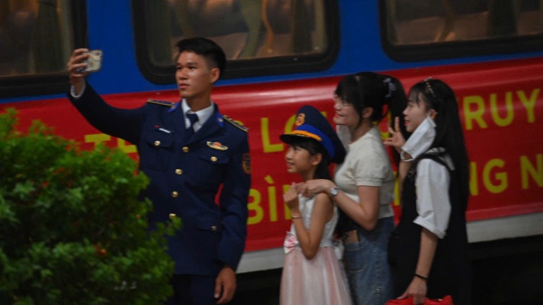 Một chiến sĩ lưu lại khoảnh khắc kỷ niệm với người dân trước khi lên tàu.