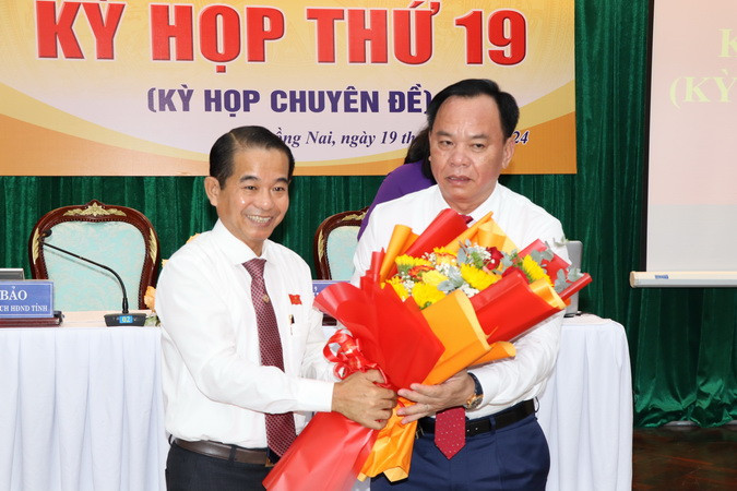 Chủ tịch Hội đồng nhân dân tỉnh Đồng Nai Thái Bảo tặng hoa chúc mừng tân Chủ tịch Ủy ban nhân dân tỉnh Đồng Nai Võ Tấn Đức.