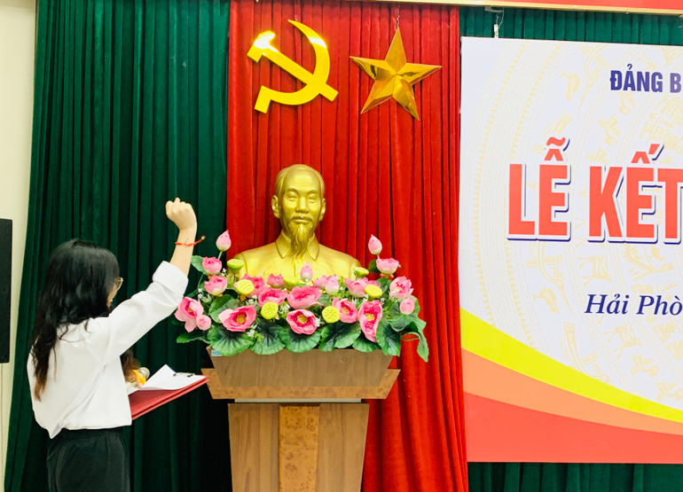 Đảng viên mới tuyên thệ trước cờ Đảng.