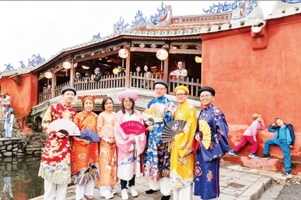 Du khách mặc Việt cổ phục khi khám phá phố cổ Hội An (Đà Nẵng).