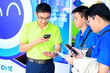 Nhân viên Ngân hàng ACB giới thiệu với khách hàng các tiện ích thanh toán số. (Ảnh ACB)