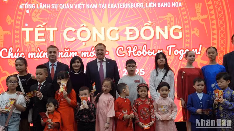 Tổng lãnh sự Việt Nam tại Ekaterinburg Nguyễn Mai Hường và đại diện phía Nga lì xì năm mới cho con em cộng đồng người Việt Nam tại Ekaterinburg. (Ảnh: XUÂN HƯNG)