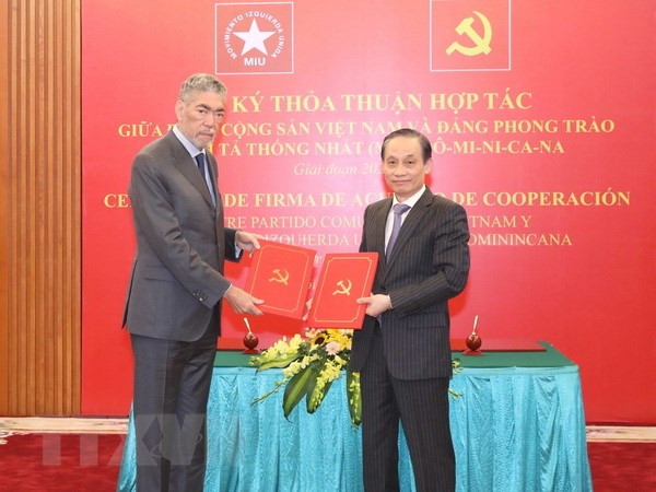 Ông Lê Hoài Trung, Ủy viên Trung ương Đảng, Trưởng Ban Đối ngoại Trung ương và ông Miguel Mejia, Tổng Bí thư Đảng Phong trào cánh tả thống nhất Dominica trao bản thỏa thuận hợp tác giữa hai Đảng. (Ảnh: TTXVN)