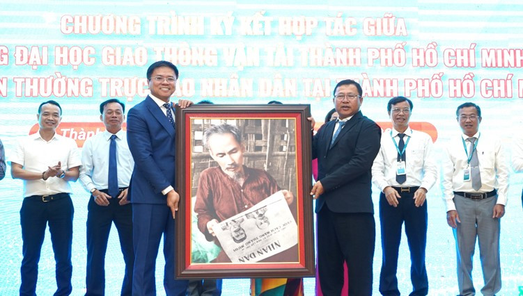 Cơ quan Thường trực Báo Nhân Dân tại Thành phố Hồ Chí Minh tặng Trường đại học Giao thông vận tải Thành phố Hồ Chí Minh bức tranh Bác Hồ đọc Báo Nhân Dân.