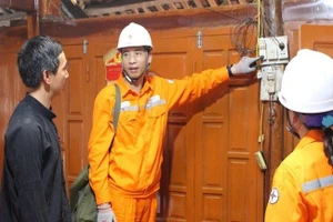 Hướng dẫn khách hàng sử dụng điện an toàn, chống chập cháy nổ tại các nhà sàn bằng gỗ nằm trong khu du lịch cộng đồng. (Ảnh: Báo Nhân Dân)