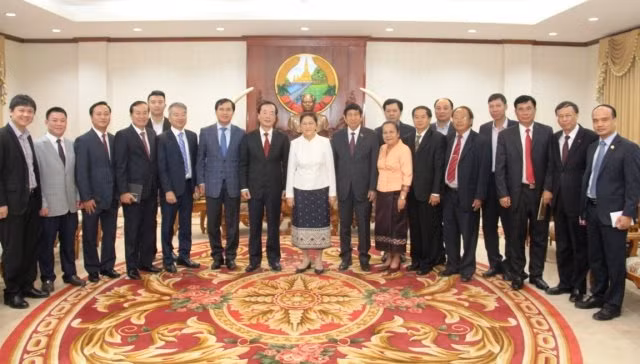 Chủ tịch Quốc hội Lào chụp ảnh lưu niệm cùng Đoàn đại biểu Bộ Xây dựng Việt Nam, sáng 26-1.