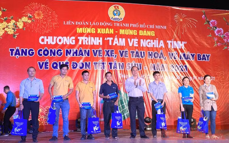 Lãnh đạo TP Hồ Chí Mình và LĐLĐ thành phố trao tấm vé nghĩa tình cho công nhân lao động tối 26-1.