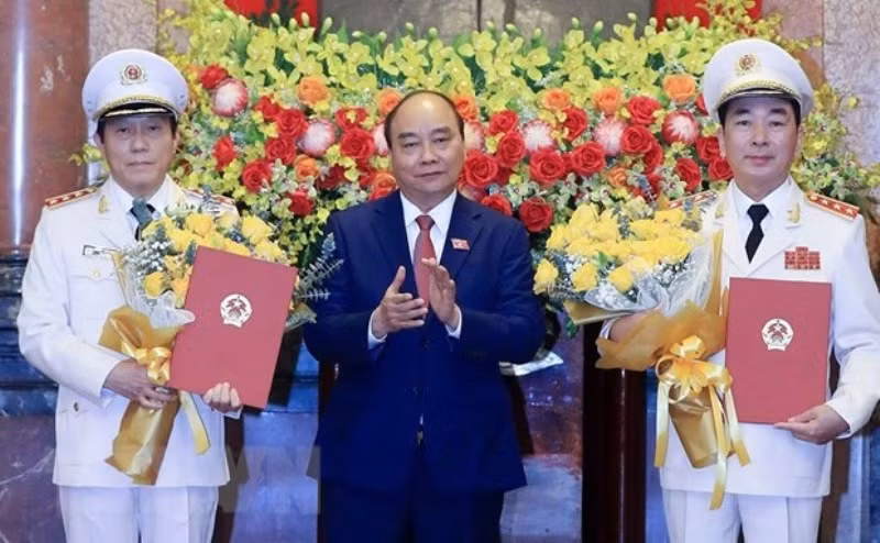Chủ tịch nước Nguyễn Xuân Phúc trao Quyết định thăng cấp bậc hàm từ Trung tướng lên Thượng tướng đối với Thứ trưởng Công an Trần Quốc Tỏ và Lương Tam Quang. (Ảnh: Thống Nhất/TTXVN)