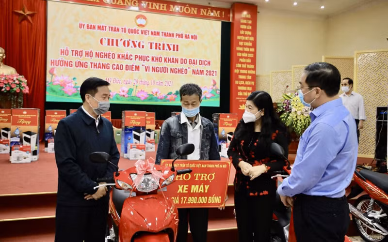 Lãnh đạo Ủy ban Mặt trận Tổ quốc Việt Nam thành phố Hà Nội trao tặng xe máy tới hộ gia đình có hoàn cảnh khó khăn.