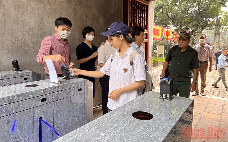 Khách du lịch quẹt thẻ để vào tham quan di tích Văn Miếu - Quốc Tử Giám.