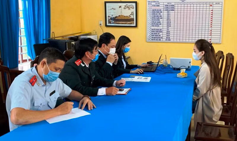 Cơ quan chức năng làm việc với chủ tài khoản mạng xã hội sai phạm (bên phải).