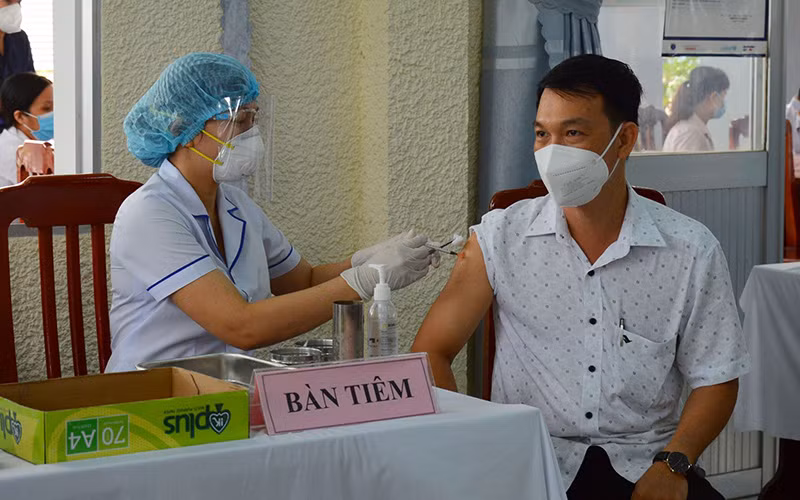 Tiêm liều vaccine nhắc lại cho đối tượng theo quy định tại Trung tâm Kiểm soát bệnh tật tỉnh Đồng Tháp. (Ảnh: TTXVN)