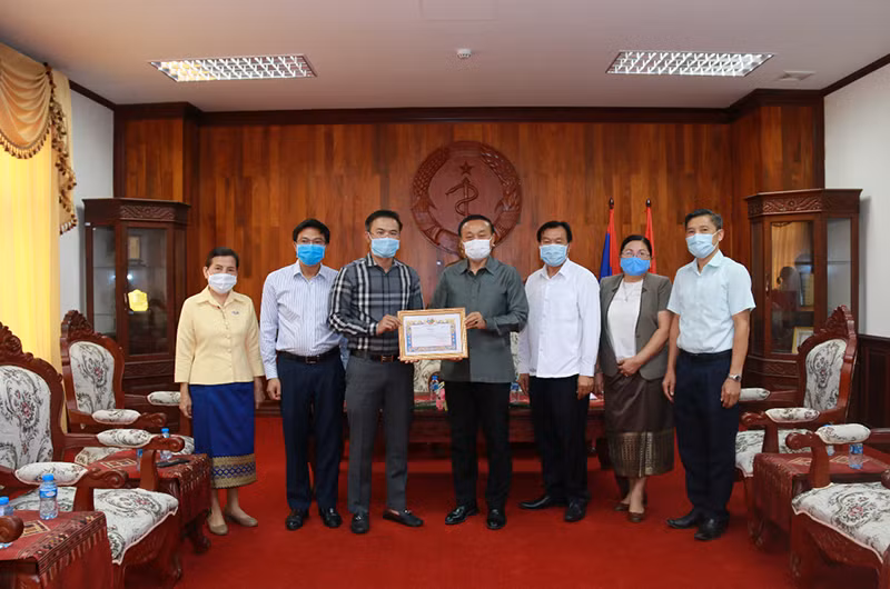 Bộ trưởng Y tế Lào Bounfeng Phoummalaysith (giữa) và ông Nguyễn Đức Vũ, Tổng Giám đốc LaoVietBank tại lễ đón nhận quyên góp.
