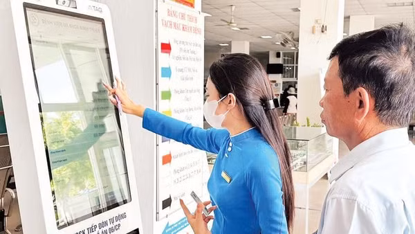 Nhân viên Bệnh viện Đa khoa Ninh Thuận, tỉnh Khánh Hòa hướng dẫn người dân đăng ký khám bệnh bằng căn cước công dân có gắn chip theo đề án 06 của Chính phủ.