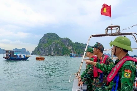 Cán bộ, chiến sĩ Đồn Biên phòng Hạ Long (tỉnh Quảng Ninh) kêu gọi tàu bè vào nơi tránh, trú bão an toàn. (Ảnh: NGUYỄN KHÁNH)