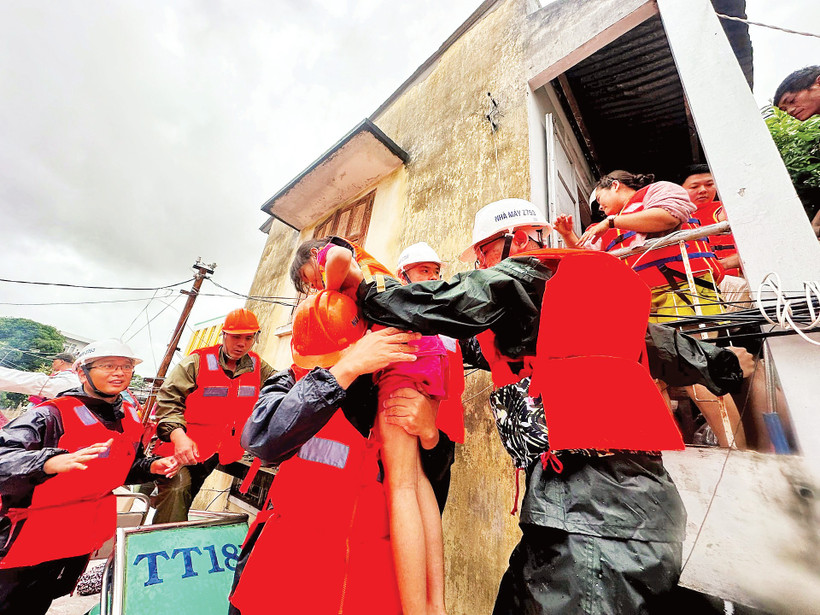 Cán bộ, chiến sĩ Nhà máy Z753 cứu giúp người dân Khánh Hòa ra khỏi vùng ngập sâu.