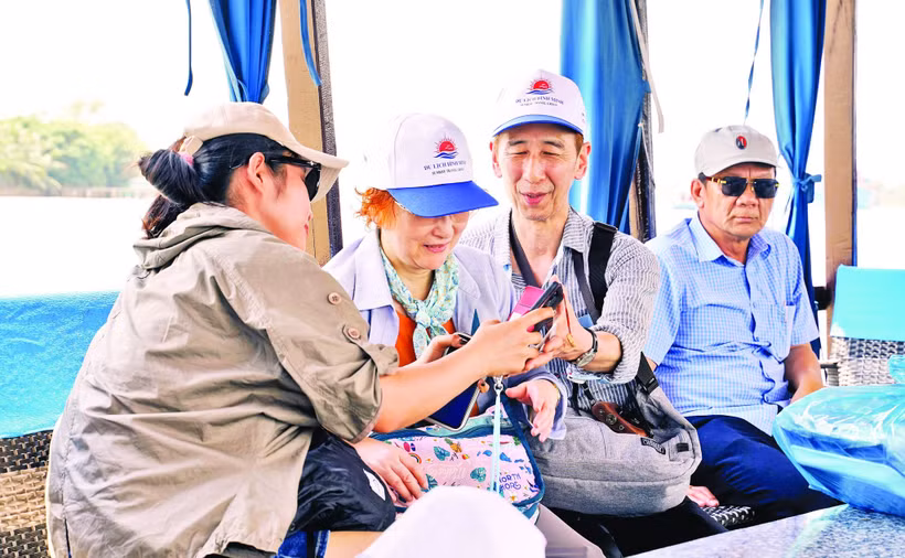 Bạn trẻ hướng dẫn vợ chồng du khách Nhật tham quan miền Tây. Ảnh: Nguyệt Anh