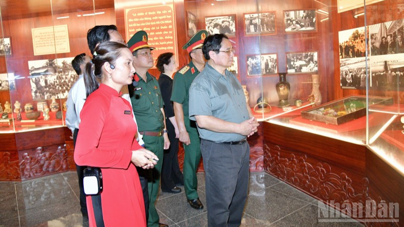 Thủ tướng Phạm Minh Chính nghe giới thiệu về các hiện vật tại khu lưu niệm. ndo_br_d3-1458.jpg