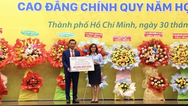 Tiến sĩ Lê Lâm, Hiệu trưởng Trường cao đẳng Đại Việt Sài Gòn tiếp nhận học bổng từ các mạnh thường quân hỗ trợ cho sinh viên khó khăn.
