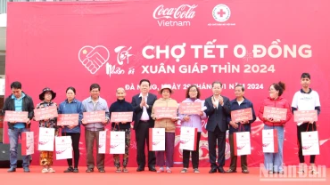 Đồng chí Nguyễn Trọng Nghĩa và Nguyễn Văn Quảng trao quà tặng các hộ nghèo tại chương trình "Chợ Tết 0 đồng".