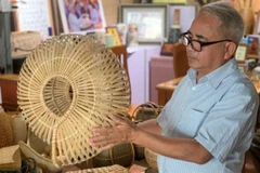 Nghệ nhân Nguyễn Văn Tĩnh giới thiệu sản phẩm mang tên “Bộ ốc bằng tre”.