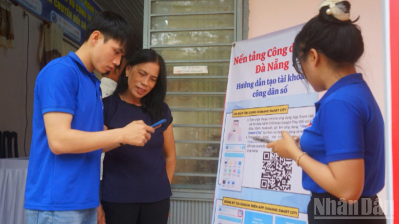 Thanh niên tình nguyện hướng dẫn người dân cài đặt ứng dụng Danang smart city.