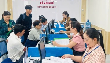 Cán bộ, viên chức xã An Phú hướng dẫn thủ tục hành chính cho người dân vùng biển Quảng Ngãi. (Ảnh ĐÔNG HUYỀN)