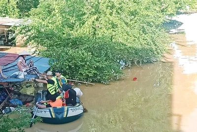 Lũ ngập đến mái nhà, lực lượng cứu hộ đón vợ anh Ngô Văn Hùng ở tổ 17, phường Phan Đình Phùng đến nơi an toàn. 