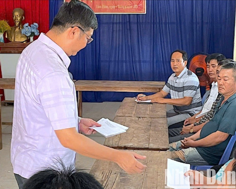 Chủ tịch Ủy ban nhân dân huyện Đầm Dơi Lê Minh Hiền (bên trái) trao khoản hỗ trợ cho các hộ dân có nhà bị ảnh hưởng do sạt lở đất ven sông trên địa bàn xã Nguyễn Huân. sat-lo-4-2066.jpg