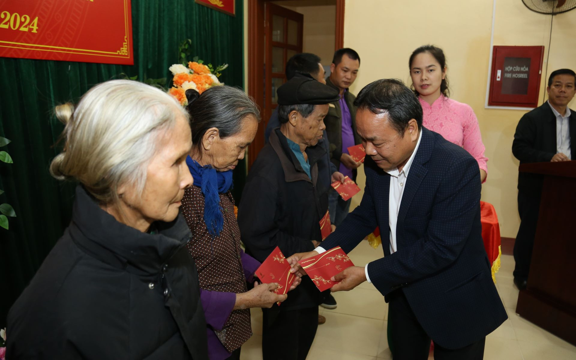Đồng chí Đinh Như Hoan, Phó Tổng Biên tập Báo Nhân Dân trao quà cho các hộ gia đình khó khăn.