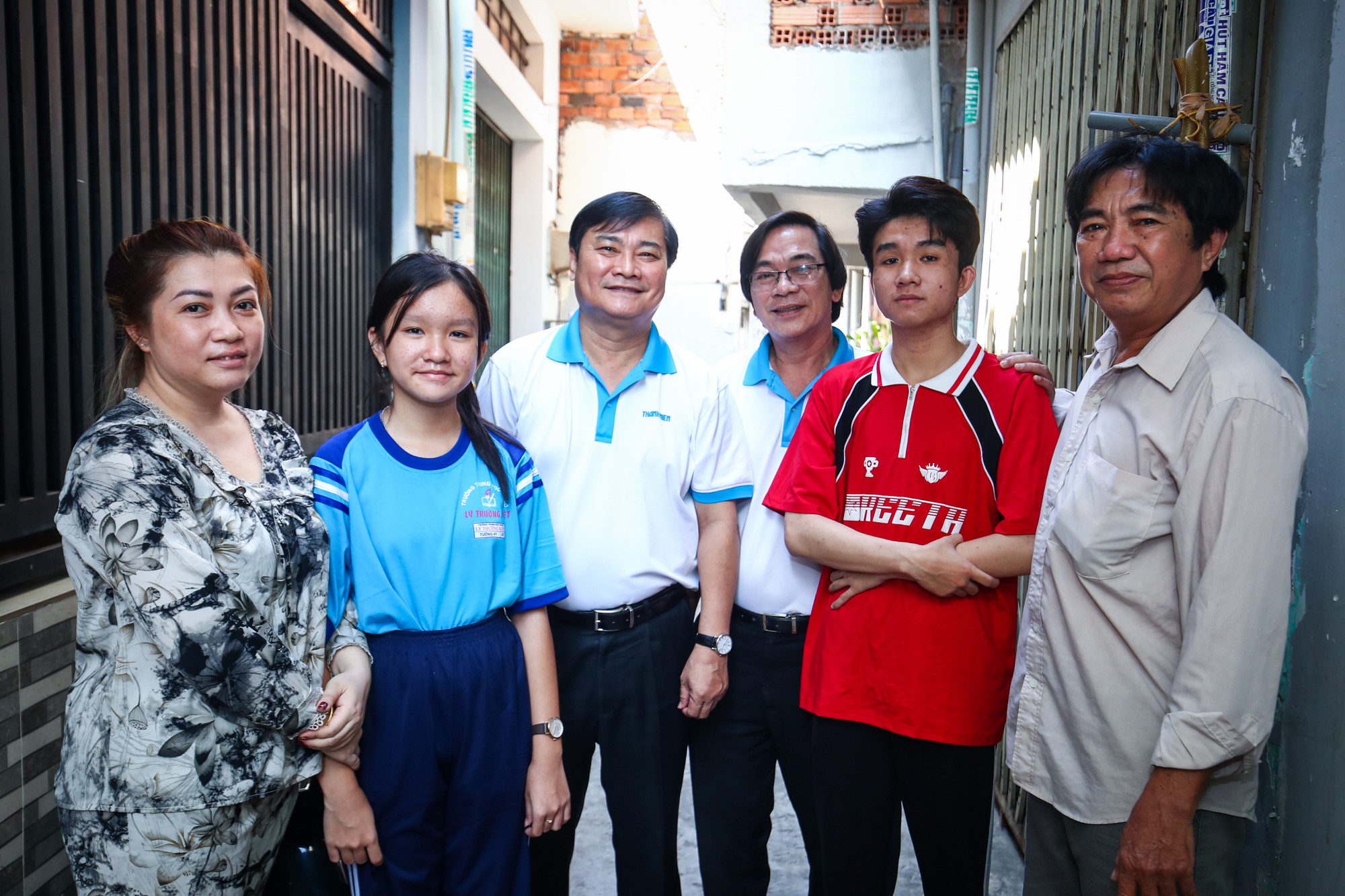 Tổng biên tập Nguyễn Ngọc Toàn (thứ 3, từ trái sang) cùng gia đình 2 anh em Trí và Vy được chương trình nhận hỗ trợ.