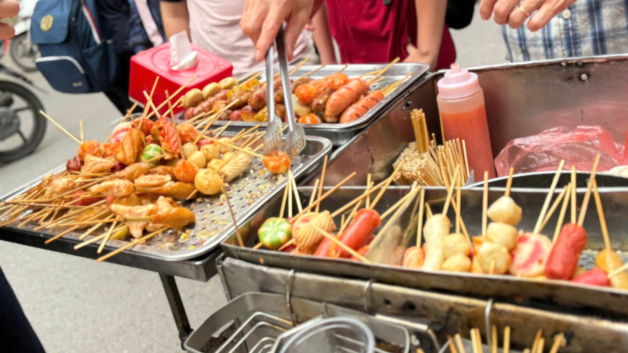 Thực phẩm đường phố được bày bán tràn lan, giá rẻ tại các cổng trường học chứa nhiều yếu tố nguy cơ gây ra tình trạng ngộ độc thực phẩm.