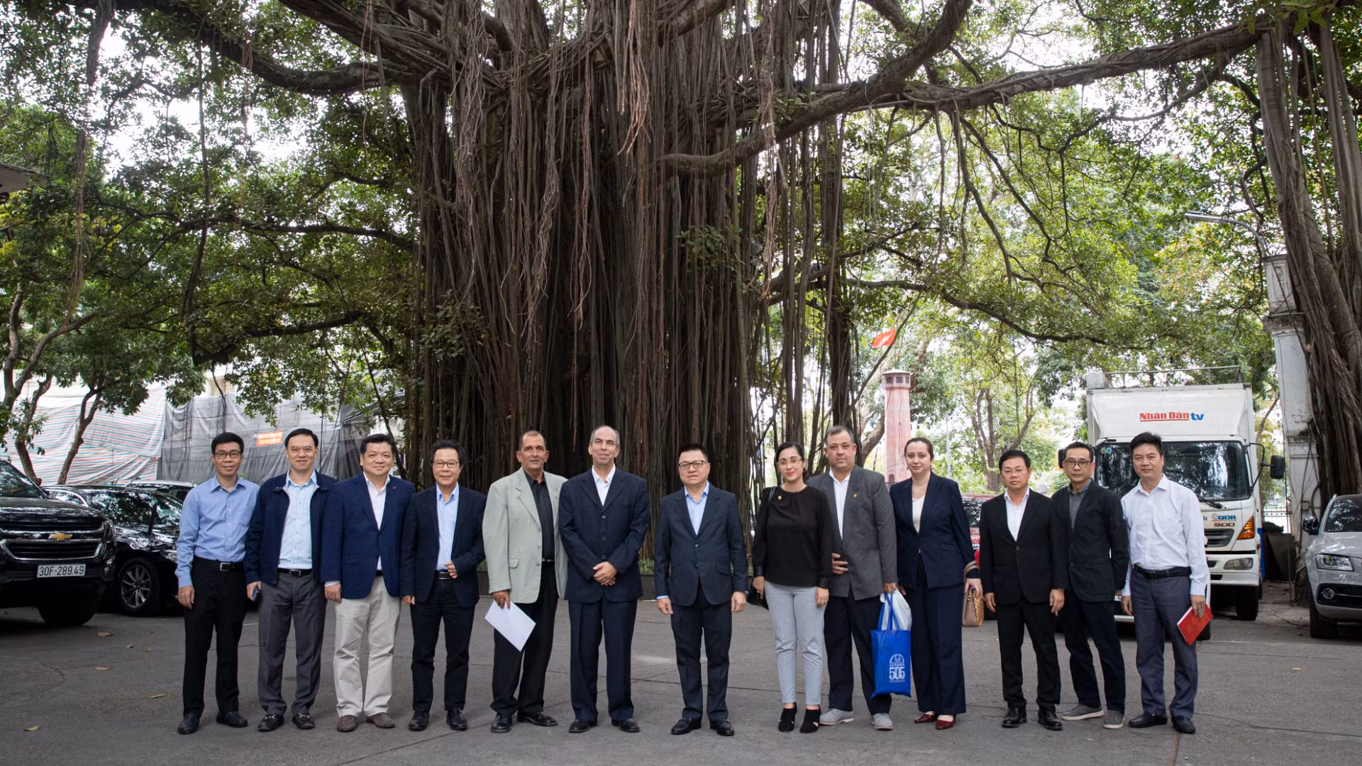 Các đại biểu chụp ảnh lưu niệm dưới gốc đa Hàng Trống trong khuôn viên Báo Nhân Dân. (Ảnh: SƠN TÙNG)