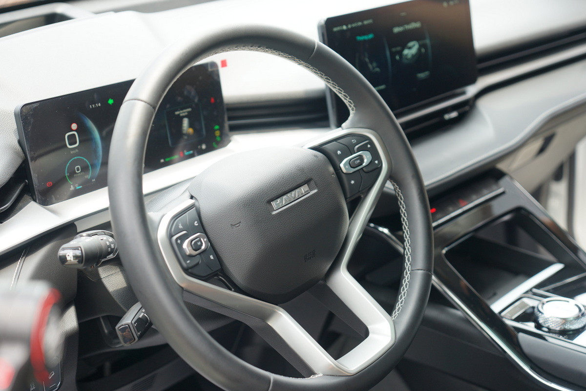 Vô-lăng 3 chấu bọc da tích hợp nhiều phím chức năng với viền kim loại, cần số điện tử dạng núm xoay.