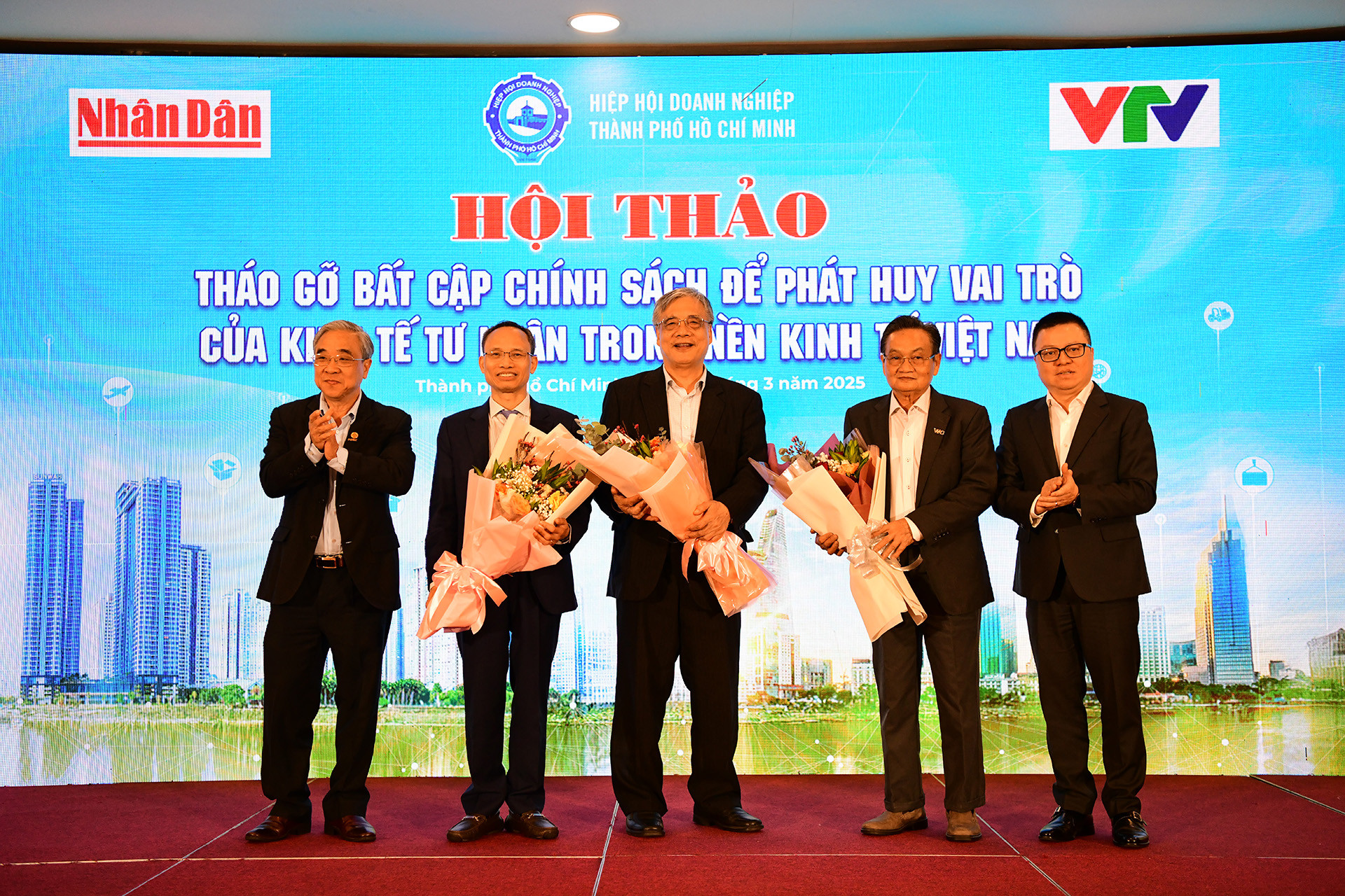 Ban Tổ chức tặng hoa kỷ niệm tới các chuyên gia kinh tế tham dự hội thảo.