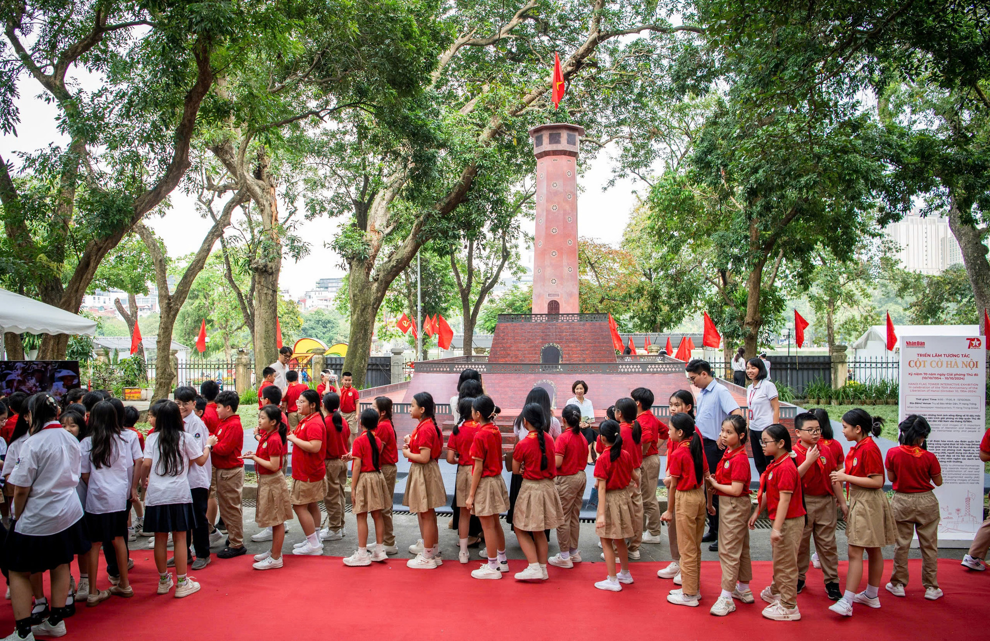 Các em học sinh tiến vào tham quan mô hình Cột cờ Hà Nội được dựng tại Báo Nhân Dân.