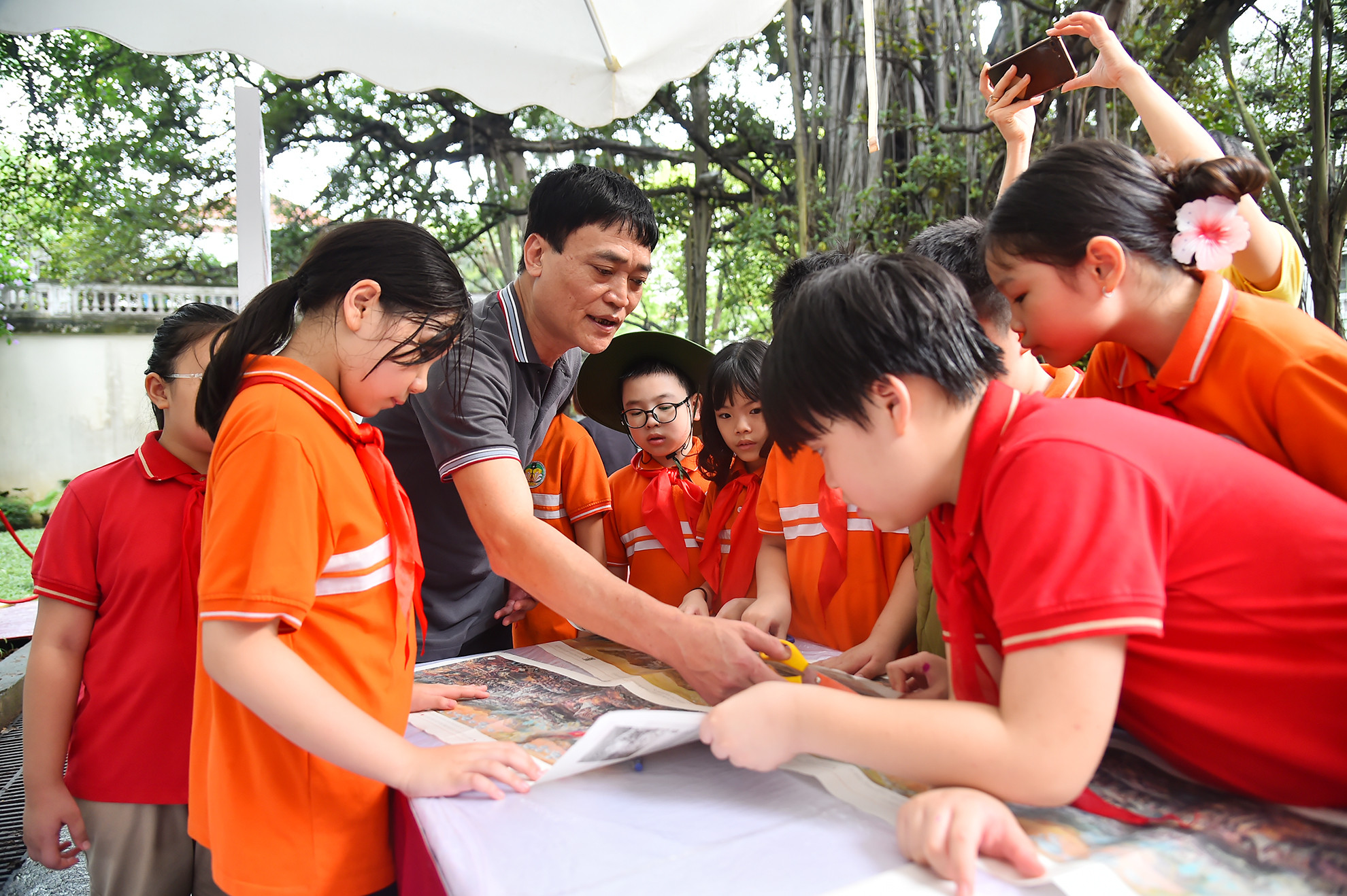 Các bạn học sinh cùng nhau cắt, dán bức tranh panorama “Chiến dịch Điện Biên Phủ”.