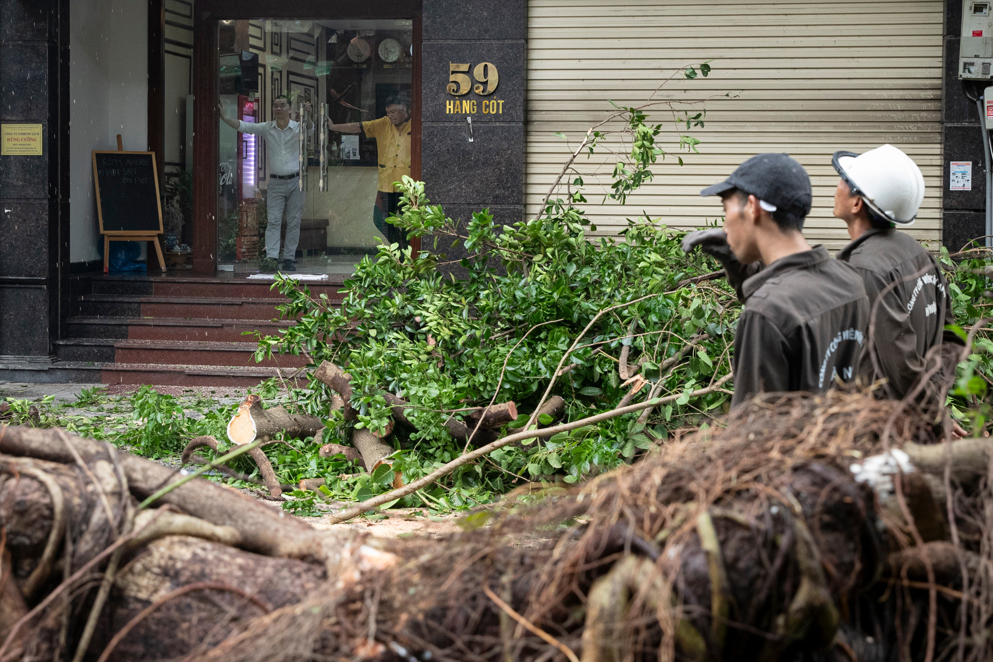 Sau 4 giờ làm việc vất vả, những khúc cây cuối cùng đã được hạ xuống, giải phóng đường đi cho những hộ dân tại phố Hàng Cót.