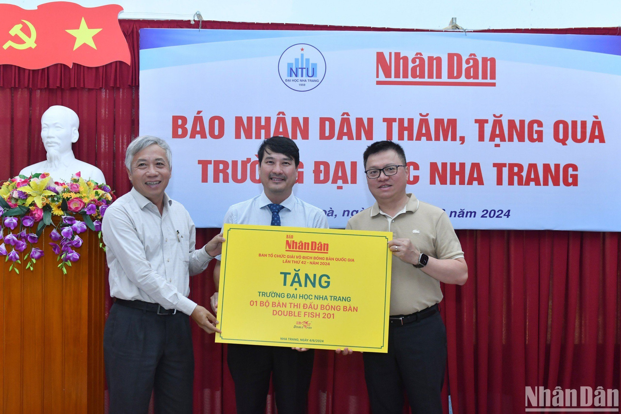 Lãnh đạo Trường Đại học Nha Trang nhận món quà từ Báo Nhân Dân.