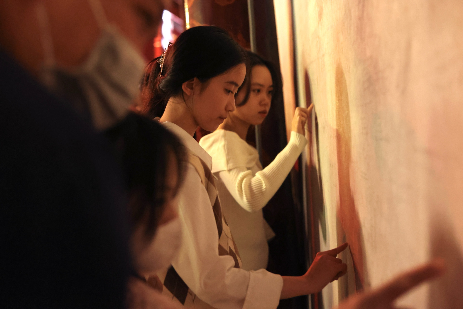 Các bạn trẻ thích thú viết lên tường bằng tay những lời chúc cho bản thân một năm học mới thành công rực rỡ.