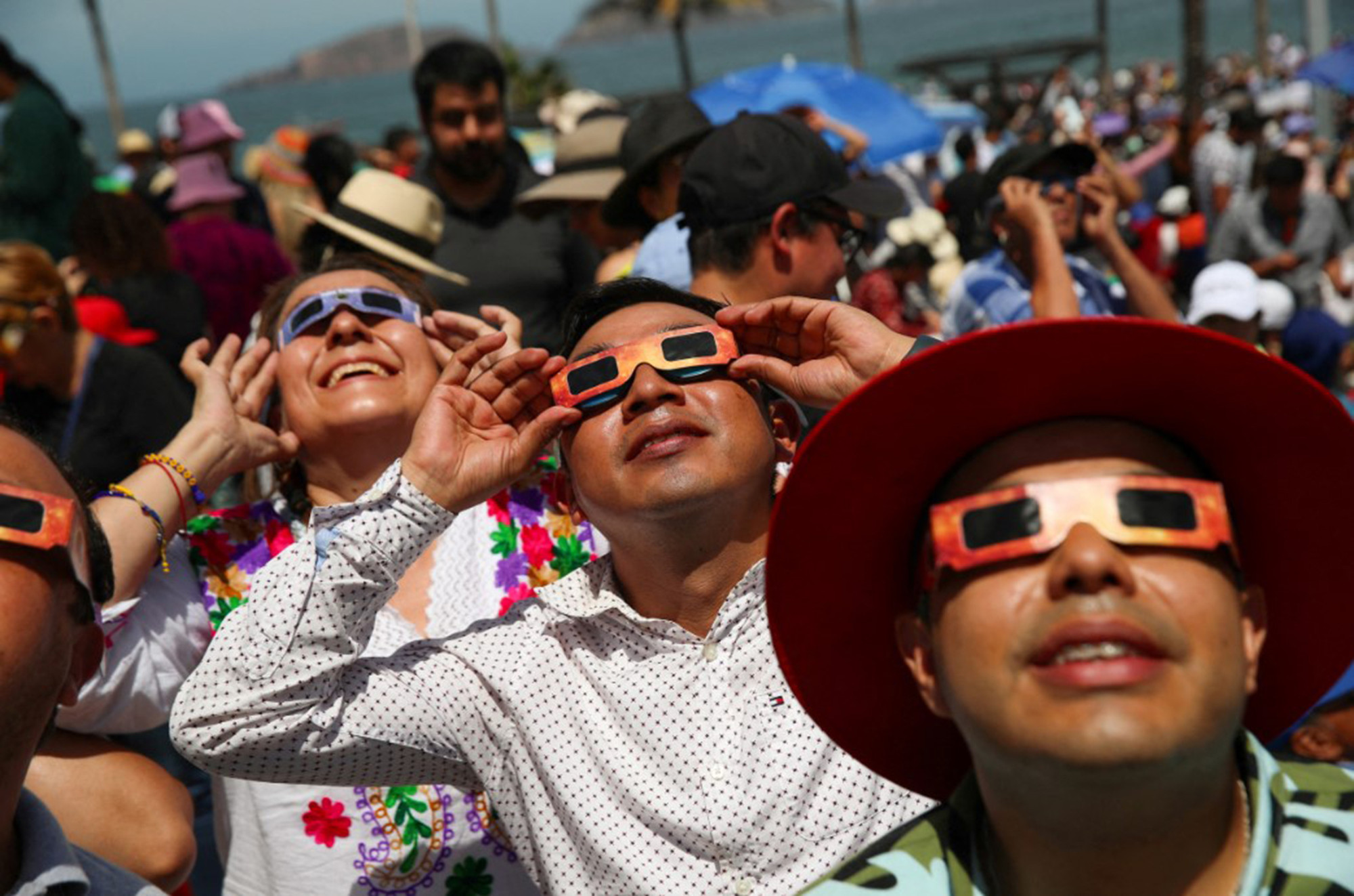 Một nhóm người theo dõi nhật thực bằng kính chuyên dụng ở Mazatlán, Mexico. (Ảnh: Reuters)