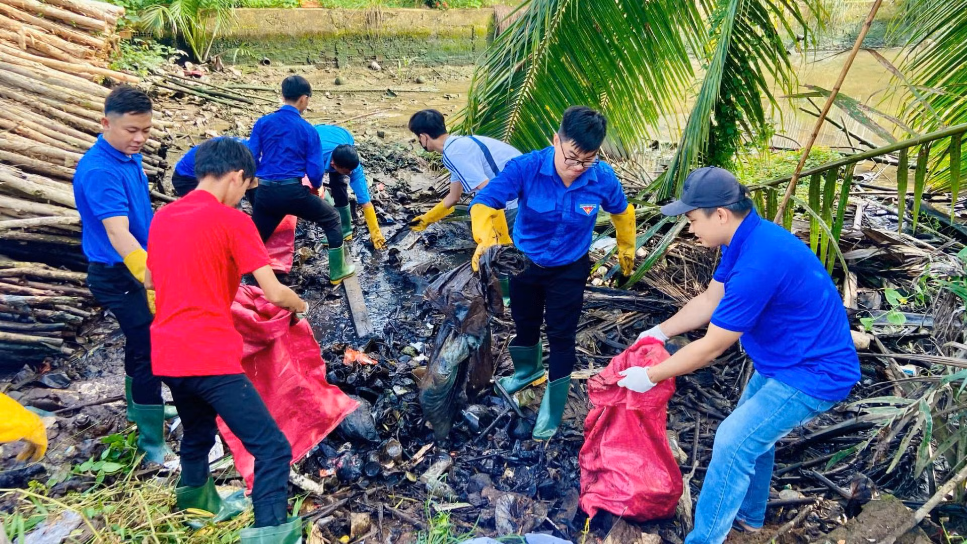 Lực lượng đoàn viên, thanh niên huyện Mỏ Cày Nam tích cực dọn dẹp vệ sinh môi trường. (Ảnh: HOÀNG TRUNG)