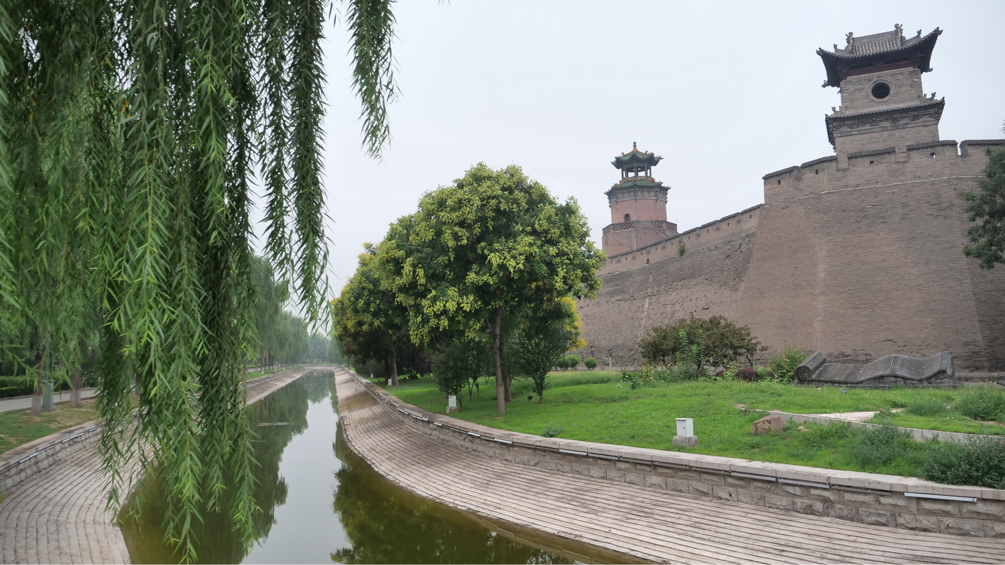 Hàng liễu xanh soi bóng xuống hào nước sâu 4m bên ngoài chân thành.