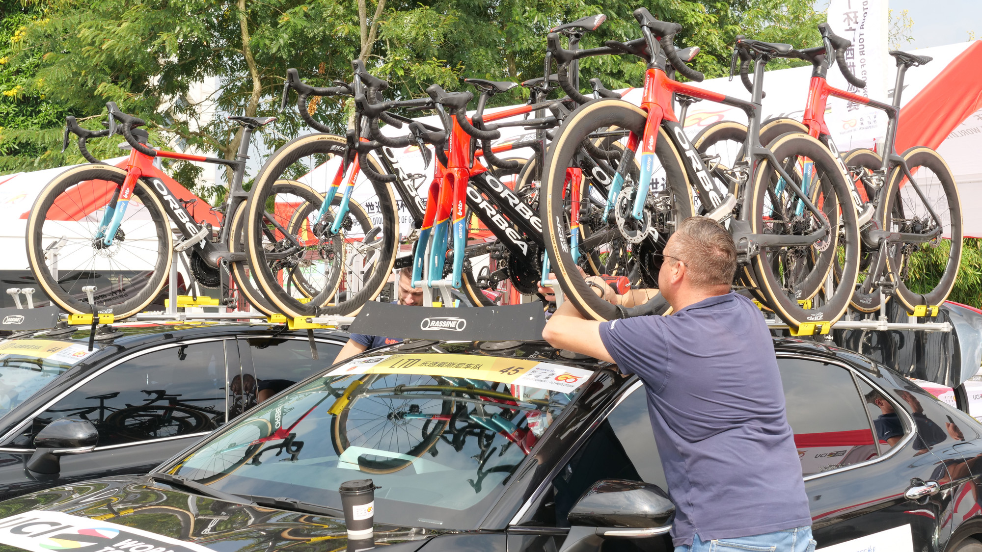 Nhân viên kỹ thuật đội Lotto Dstny kiểm tra xe đạp dự phòng trên nóc xe hậu cần.